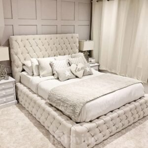 Luxurious bedroom with tufted queen size bed, decorative pillows, and matching nightstands.