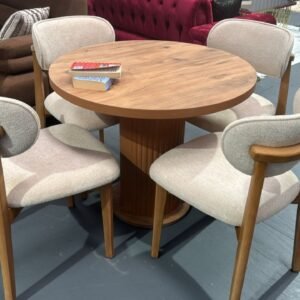 Aria Round Table Set with four beige upholstered chairs around a circular wooden table.