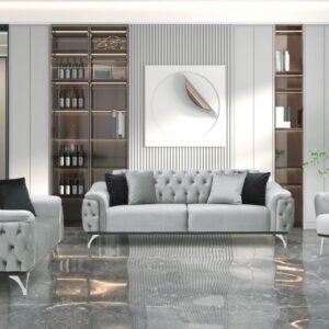 Modern living room with tufted gray sofas, a glass shelving unit with wine bottles, abstract wall art, and marble flooring.