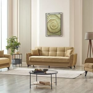 Modern living room with a tan sofa set, round coffee table, plant, and floor lamp against light beige walls and wood flooring.
