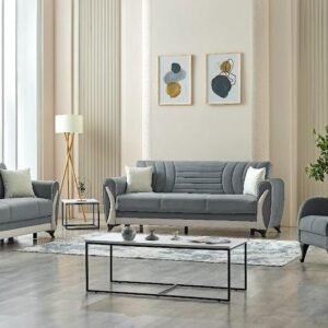 Modern living room with grey sofas, a glass coffee table, abstract wall art, and a floor lamp.