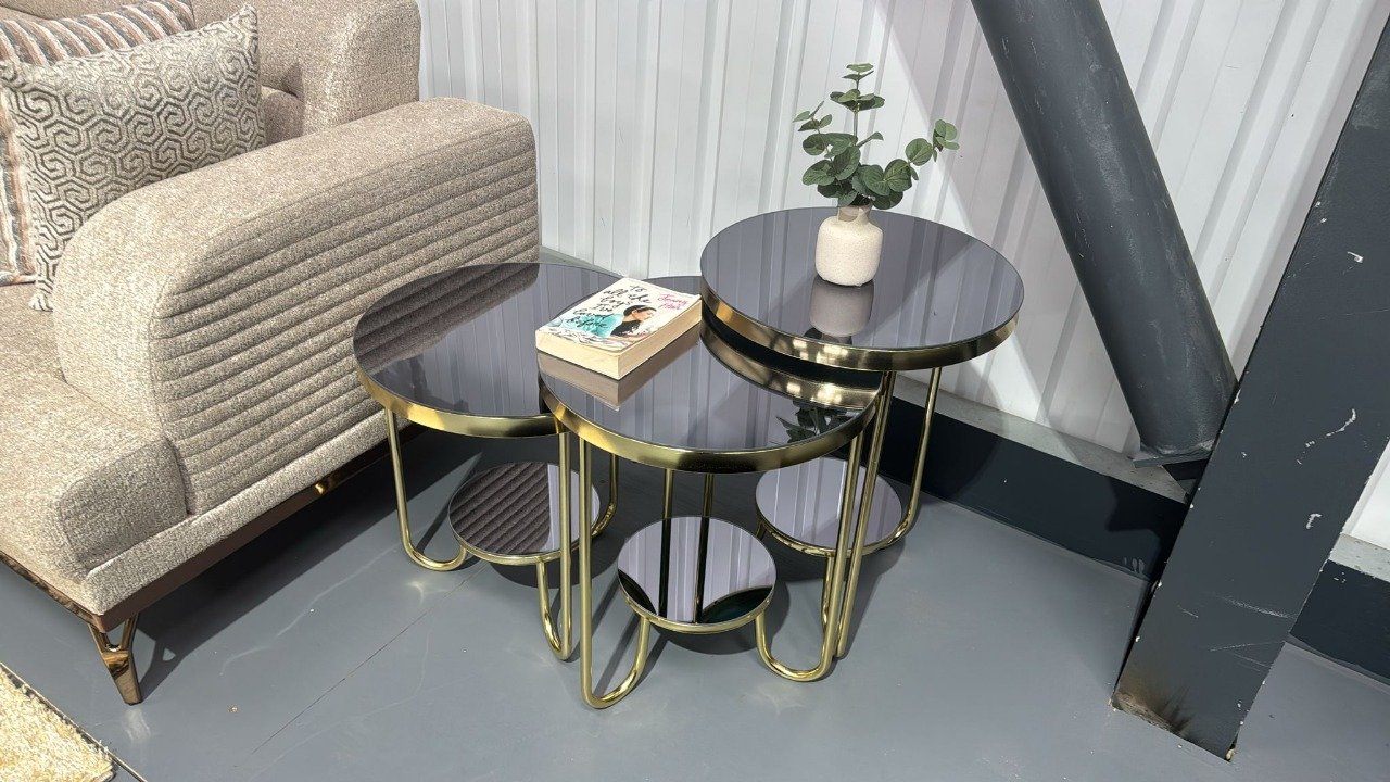 Ellis Coffee Table with black glass tops and gold frames in a modern interior.