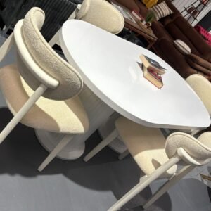 Elowen Classic Table Set with a white oval table and four matching cream-upholstered chairs.