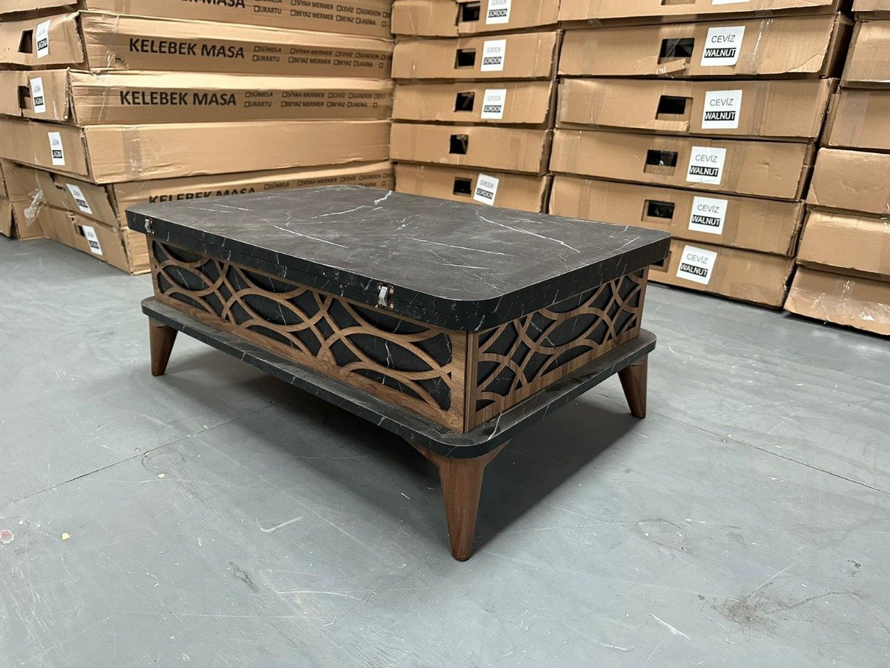 Goldcrest Coffee Table with dark marble top and decorative wooden sides.