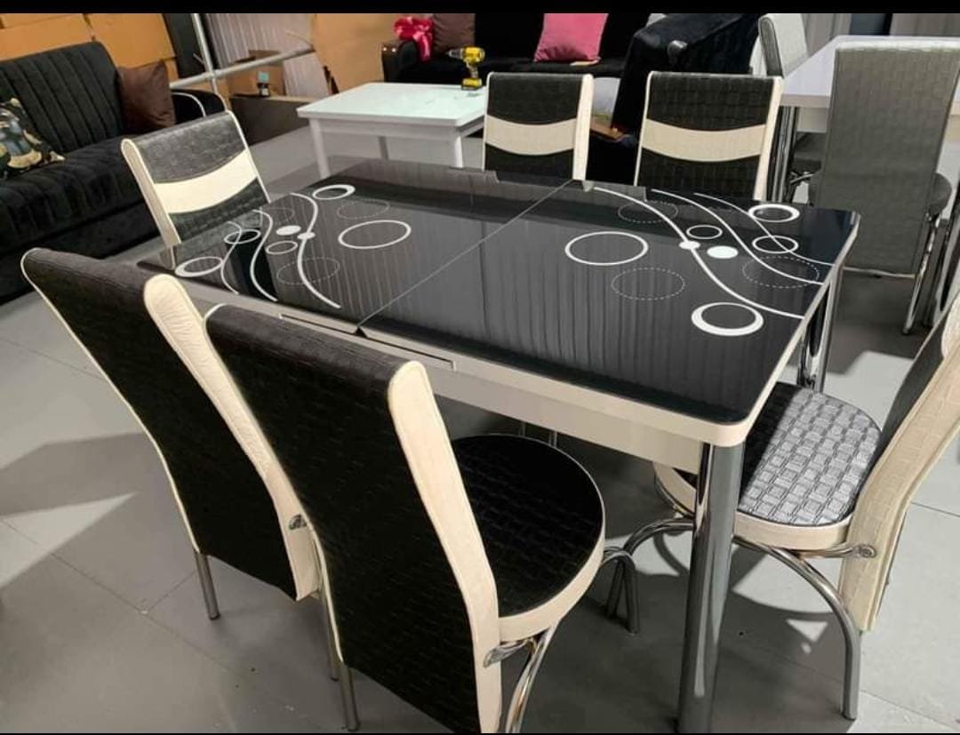LuxeFlow Dining Set with a black table and patterned white circles, surrounded by six chairs.