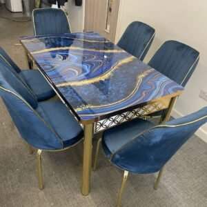 MeadowVale Dining Set with a blue and gold patterned table and six deep blue upholstered chairs.