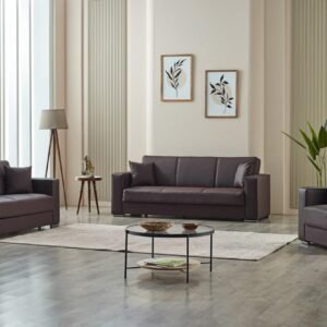 Modern living room with dark brown leather sofas, a round coffee table, and framed art on a paneled wall.