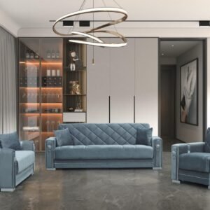 Modern living room with blue sofa, armchairs, shelving unit, and circular pendant light.