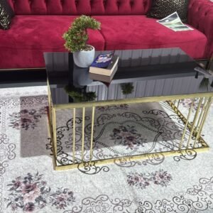 Reeve Coffee Table with a black top and gold legs in a living room.
