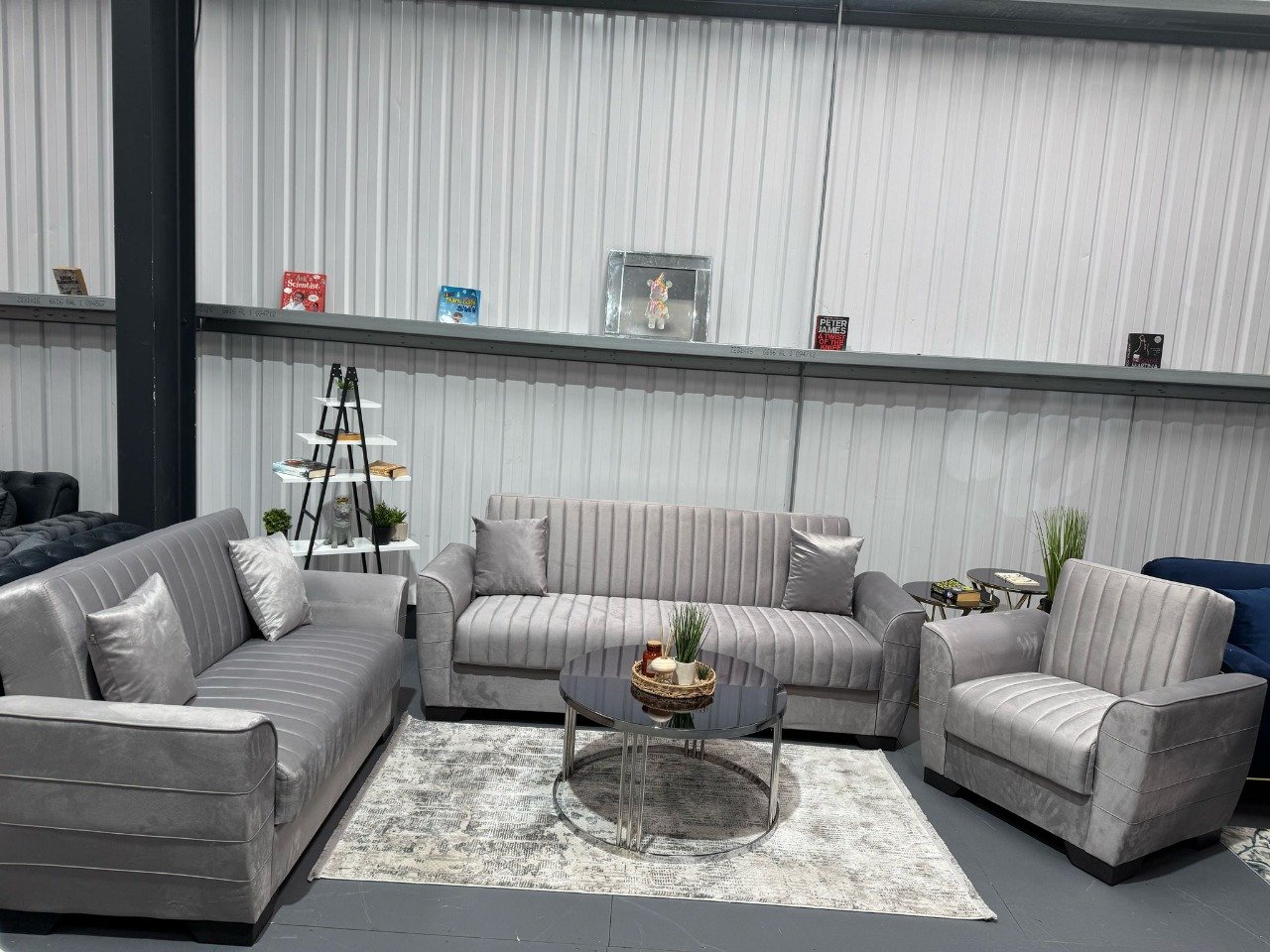 Siena Sofa Bed set in light gray upholstery with gold detailing, including a three-seater sofa, two-seater loveseat, and matching armchair.