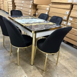 SlateEdge Dining Set with a marbled table and black chairs in a warehouse.