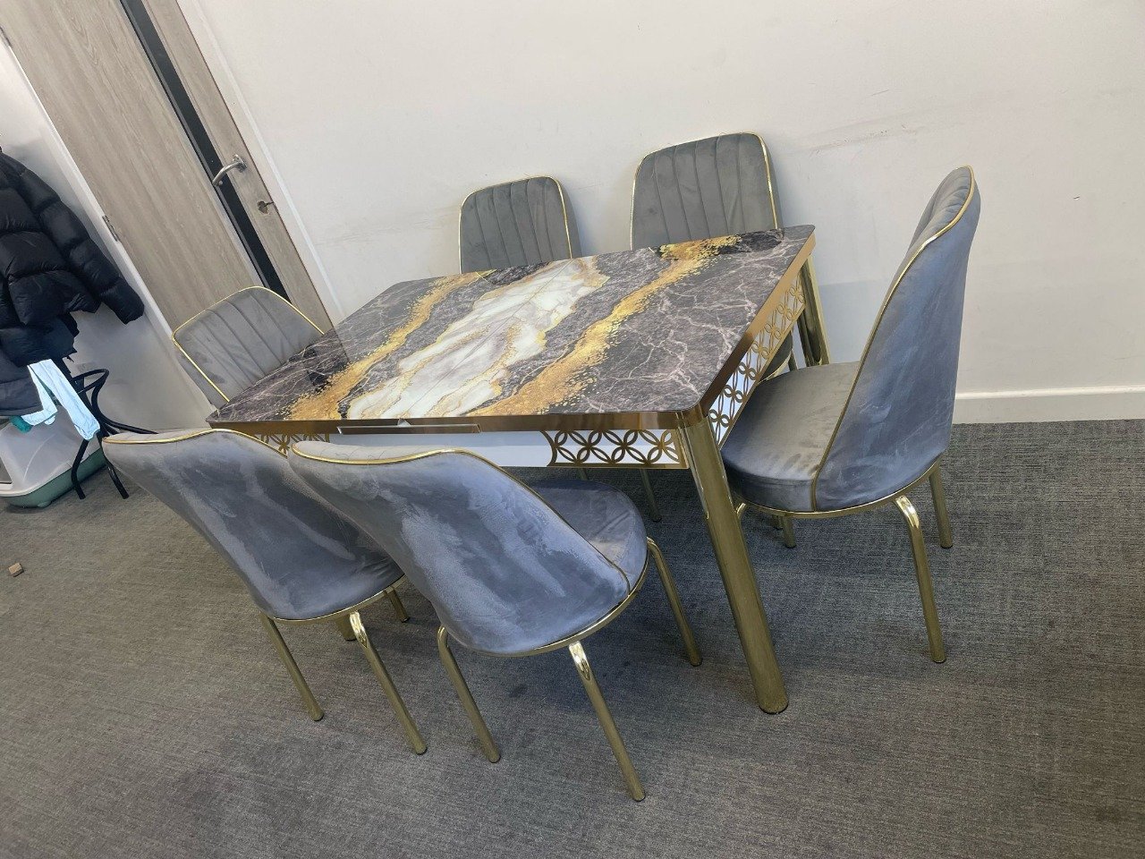 SlateEdge Dining Set with marbled tabletop and gray upholstered chairs.