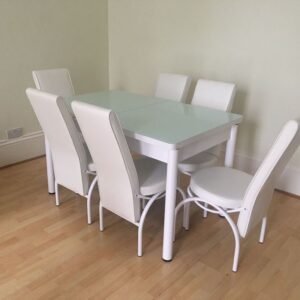 SleekAura Table Set with glass-topped table and six white high-back chairs.