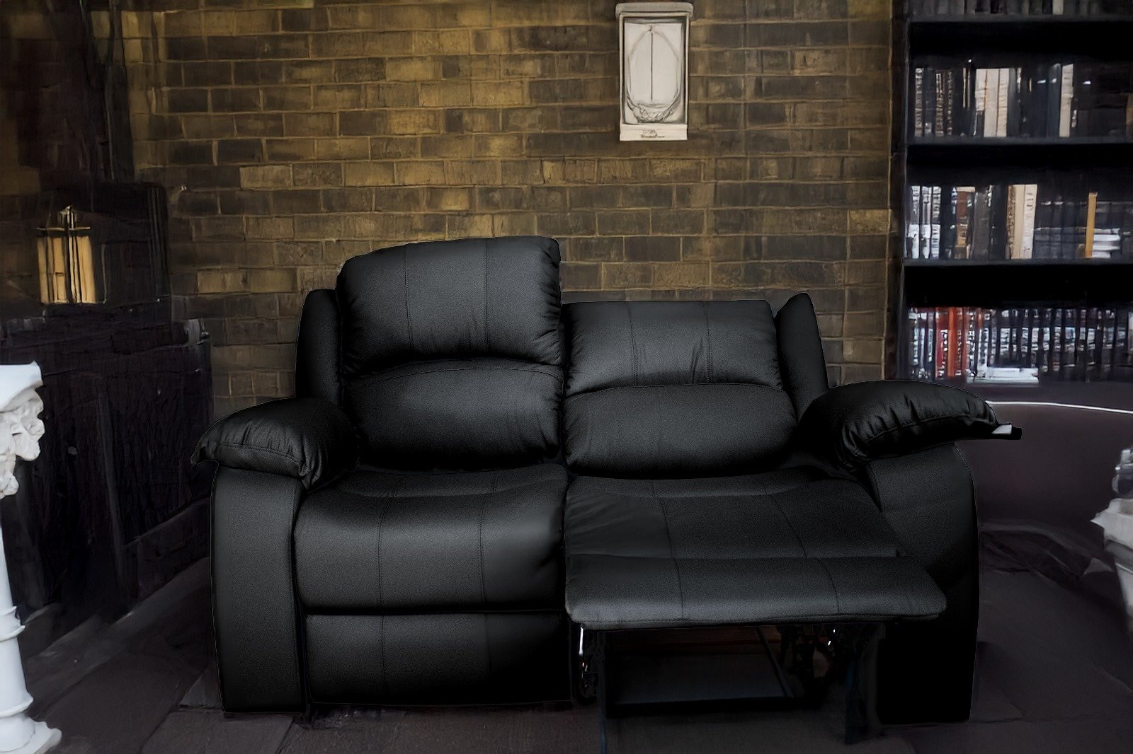 Black leather recliner sofa with a brick wall background and bookshelf on the side.