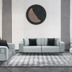 Minimalist living room with gray furniture, geometric rug, and circular wall art.