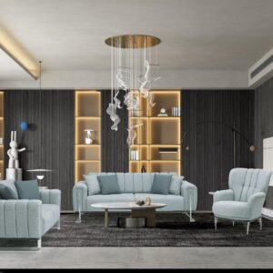 Modern living room with a light blue sofa, armchairs, and a round coffee table on a gray rug, against a backdrop of illuminated shelves and vertical wood paneling.