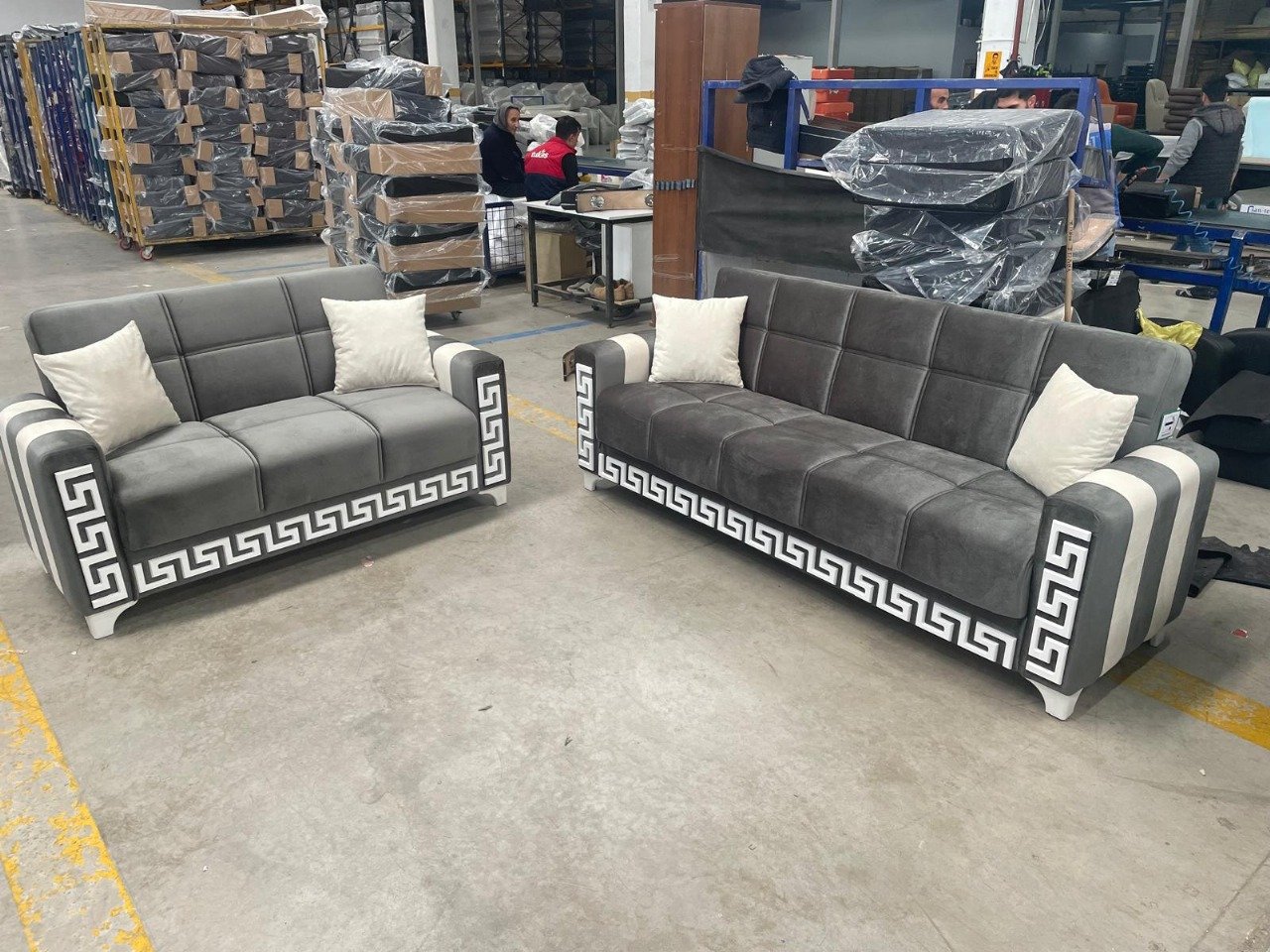 gray sofas with Greek key accents in a warehouse setting.