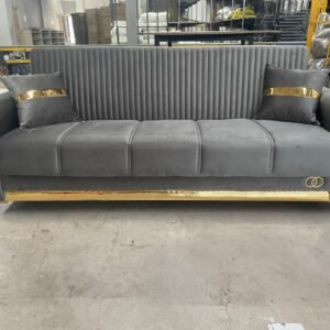 Grey sofa with gold accents in a warehouse.