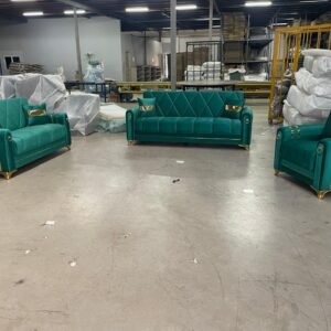 Green and gold furniture set with two sofas and an armchair in a warehouse setting.