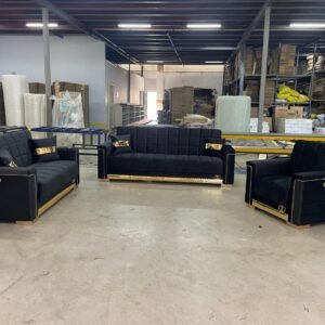 black and gold furniture set with two sofas and an armchair in a warehouse setting.