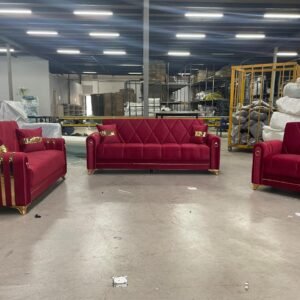 red and gold furniture set with two sofas and an armchair in a warehouse setting.