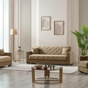 Modern living room with beige quilted furniture, a glass coffee table with golden legs, and abstract wall art.